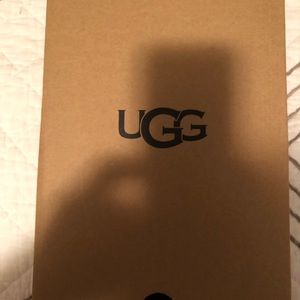 NWT (tag on bottom of shoe) size 7 orange Ugg boots in box. Never worn